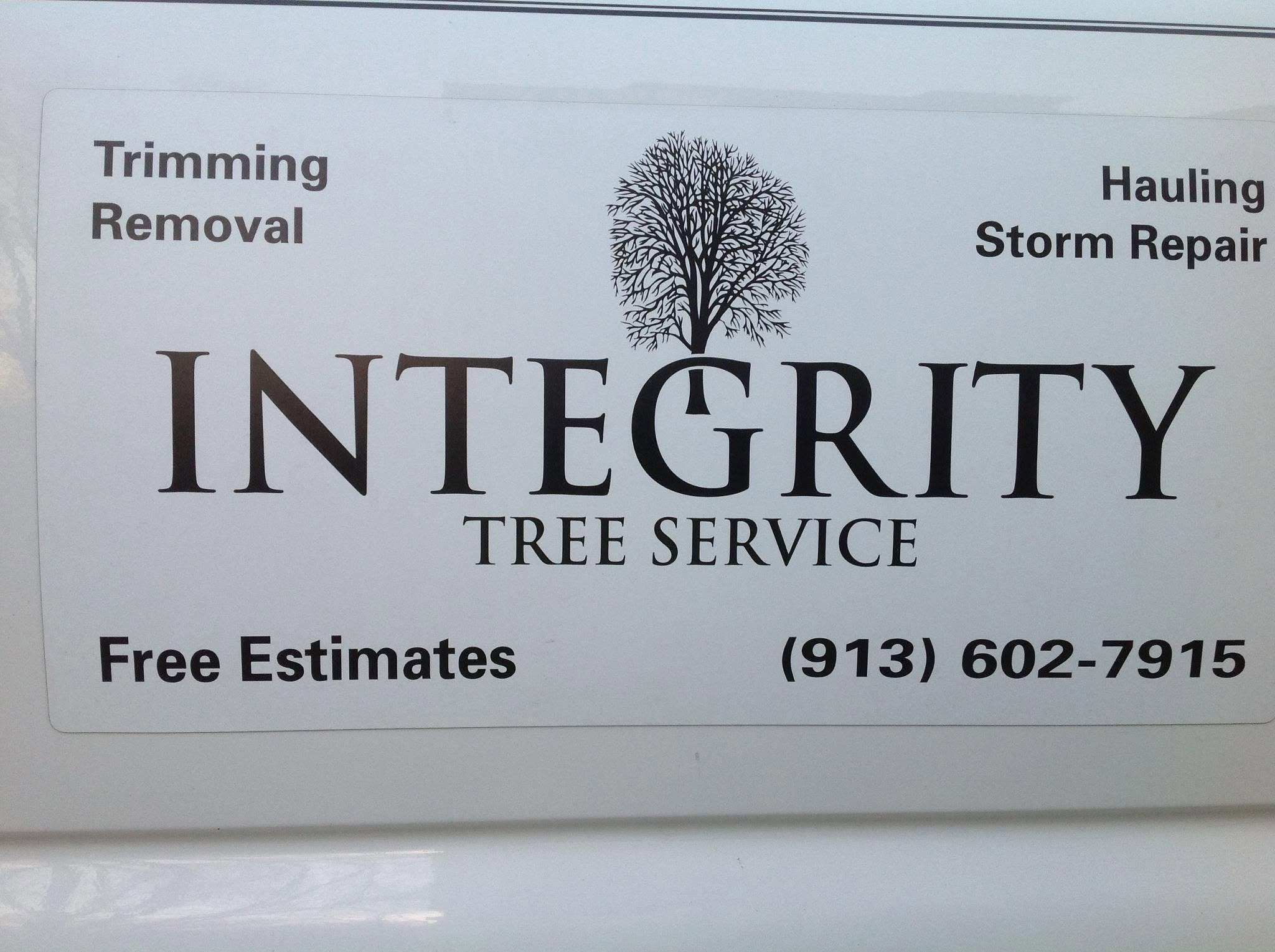 Integrity Tree Service decal on the truck door: trimming, removal, hauling, storm repair, free estimates, (913) 602-7915
